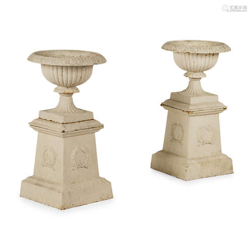 PAIR OF VICTORIAN CAST IRON URNS AND STANDS LATE 19TH CENTURY of low campana form with everted