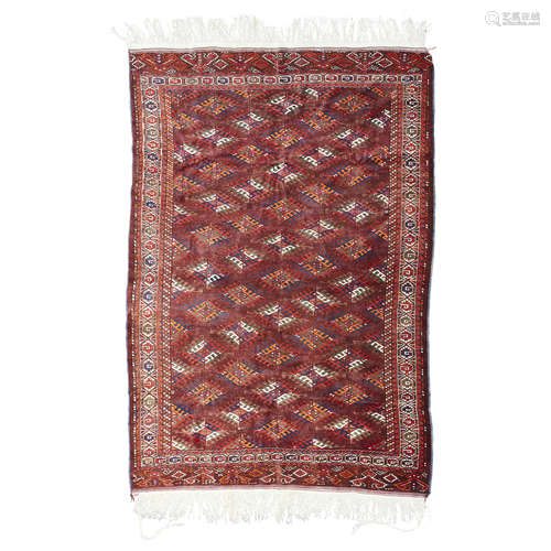 YOMUT CARPET TURKMENISTAN, MID 20TH CENTURY the brown field with allover lozenge gul pattern, within