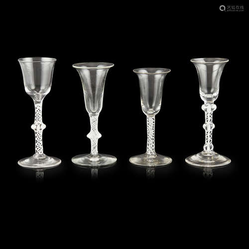 FOUR GEORGIAN OPAQUE TWIST STEM WINE GLASSES 18TH CENTURY comprising three trumpet-bowled glasses,