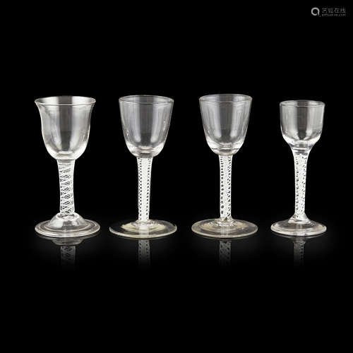 FOUR GEORGIAN OPAQUE TWIST STEM WINE GLASSES 18TH CENTURY all with double series twist stems,