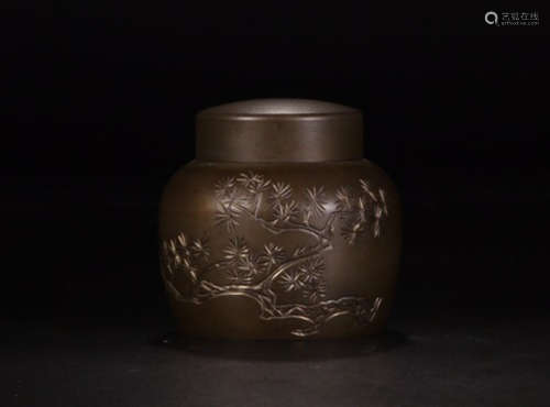 A TIN TEA LEAF JAR WITH FLOWER PATTERNS AND MARKING