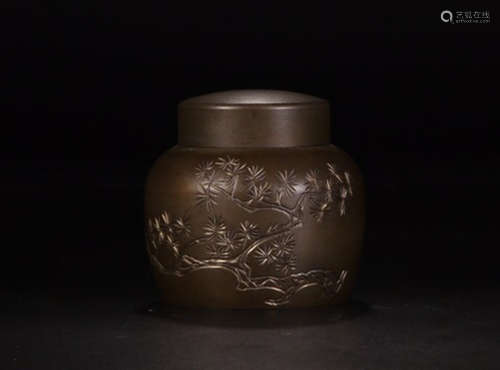 A TIN TEA LEAF JAR WITH FLOWER PATTERNS AND MARKING