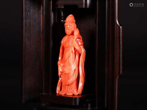 A CORAL FEMALE BUDDHA FIGURE