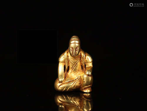 A GILT SILVER FIGURE OF KNEELING MAN