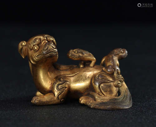 A GILT COPPER BEAST SHAPED PENDANT