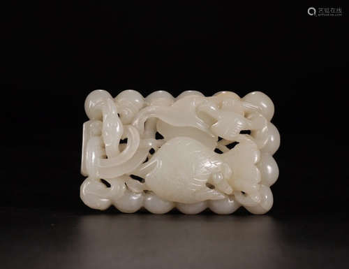 A WHITE HETIAN JADE ORNAMENT OF SLEEPING GOAT