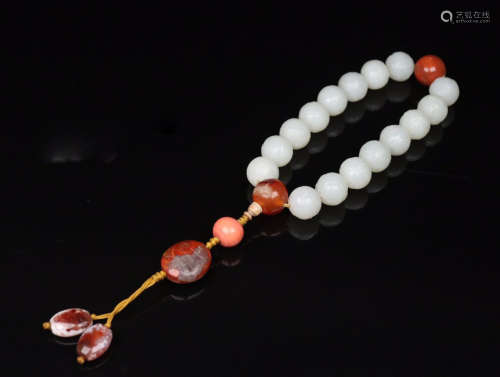 A WHITE HETIAN JADE BRACELET WITH DRAGON PATTERNS