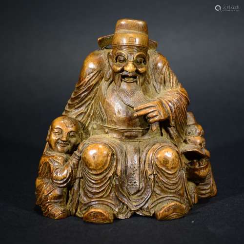 A CHINESE BAMBOO CARVED FORTUNE GOD RINDING QILIN