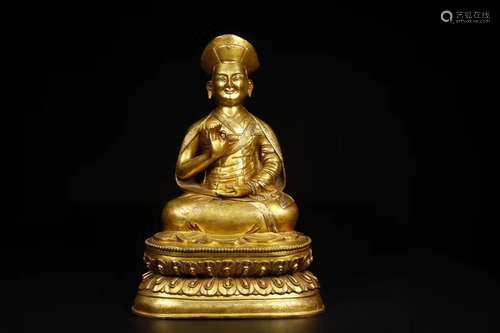 A GILT-BRONZE FIGURE OF GURU