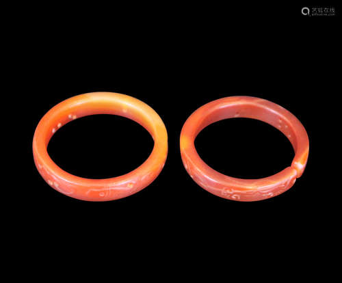 A PAIR OF JADE BANGLES WITH FISH PATTERNS