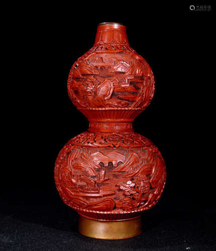 A RED LACQUER WOOD CARVED LANDSCAPE PATTERN GOURD VASE