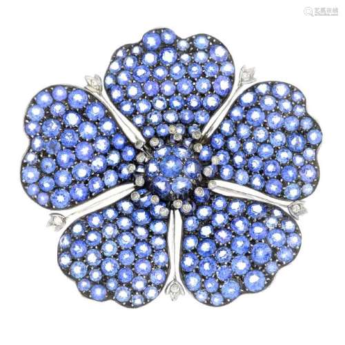 A sapphire and diamond brooch. The pave-set sapphire