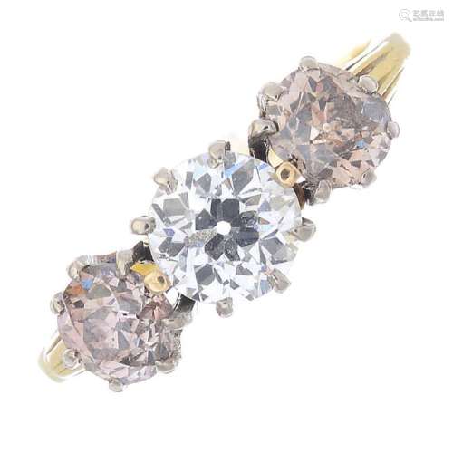 A diamond and coloured diamond three-stone ring. The