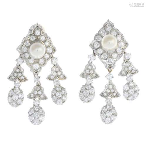 A pair of diamond and cultured pearl earrings. Each