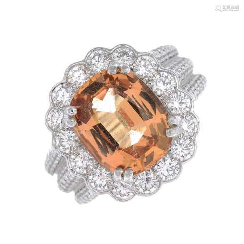 A platinum topaz and diamond cluster ring. The