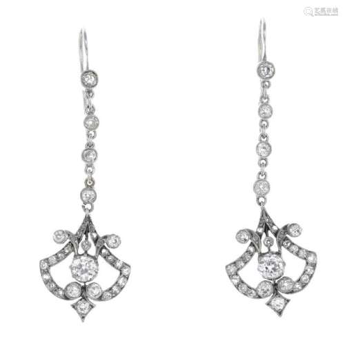 A pair of diamond earrings. Of openwork design, each