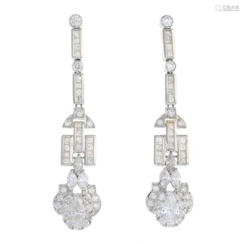 A pair of diamond earrings. Each designed as a