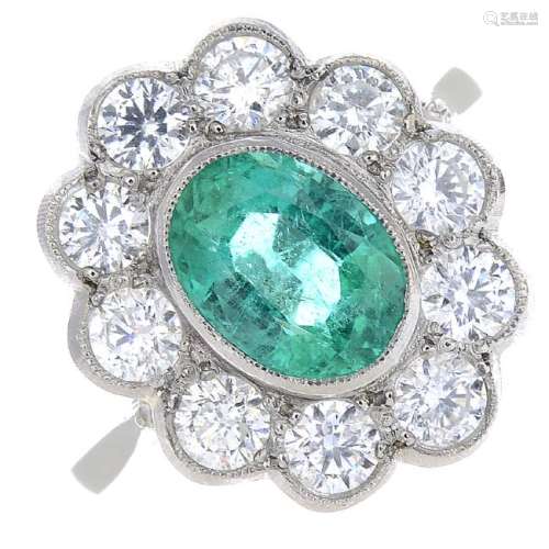 An emerald and diamond floral cluster ring. The