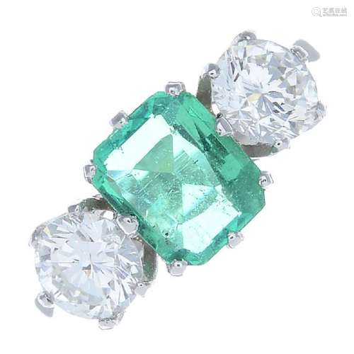 A Colombian emerald and diamond three-stone ring. The