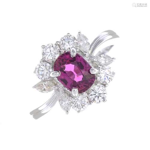 A ruby and diamond cluster ring. The cushion-shape