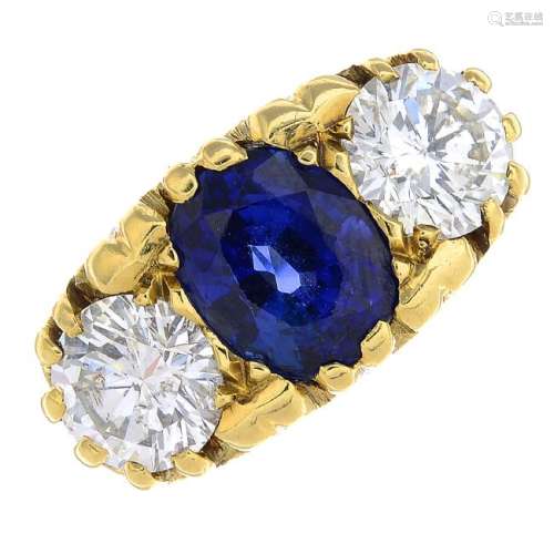 An 18ct gold sapphire and diamond three-stone ring. The