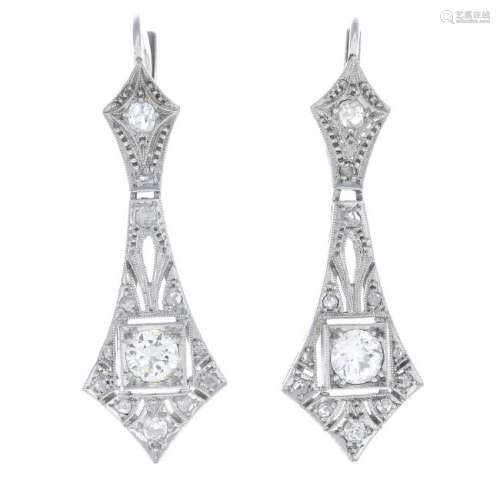 A pair of diamond earrings. Each designed as a