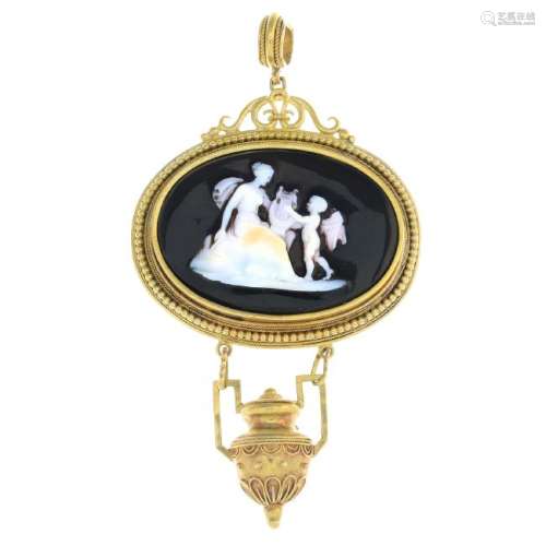 A hardstone cameo pendant. The oval onyx, carved to