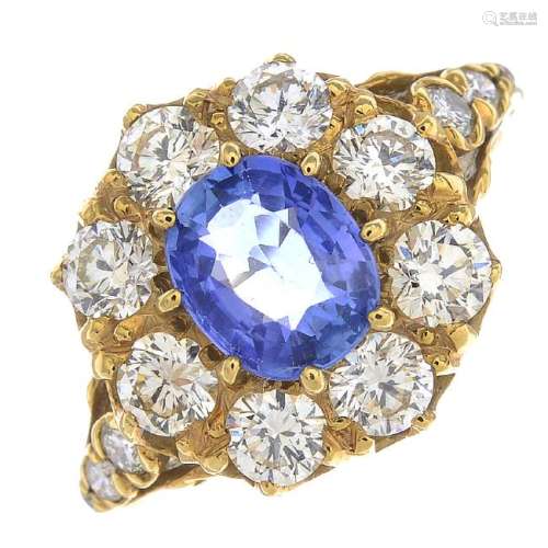 A sapphire and diamond cluster ring. The oval-shape