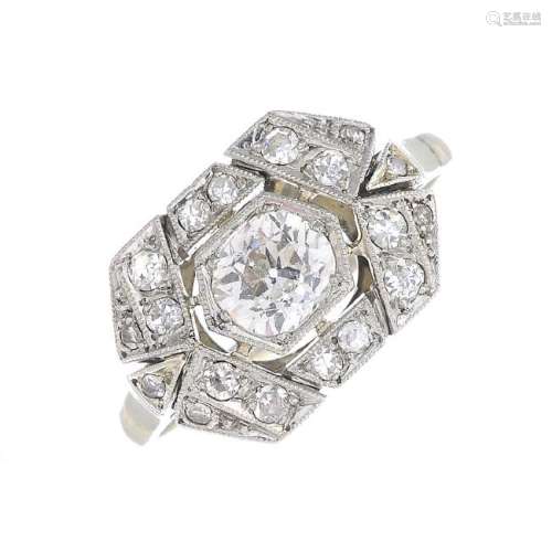 An Art Deco platinum and gold diamond ring. Of openwork