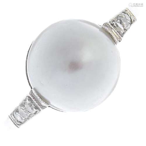 A natural pearl and diamond ring. The pearl, with