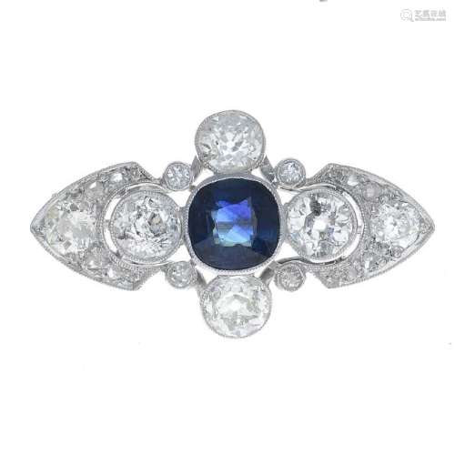 A sapphire and diamond brooch. The cushion-shape