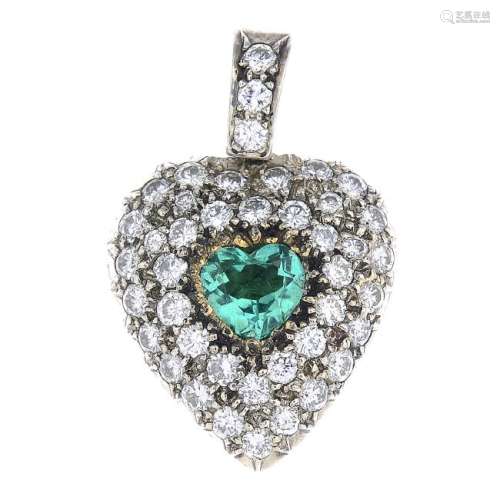 An emerald and diamond heart locket pendant. The