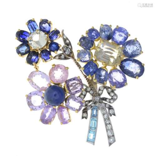 A diamond and gem-set floral spray brooch. The cabochon