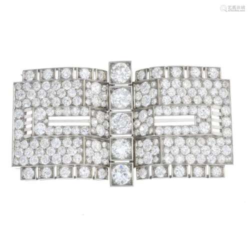 An Art Deco platinum diamond buckle brooch. The