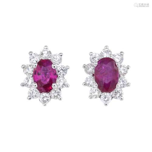 A pair of ruby and diamond cluster earrings. Each