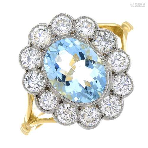 An aquamarine and diamond cluster ring. The oval-shape