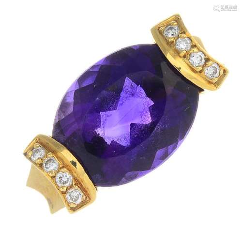 An amethyst and diamond dress ring. The oval-shape