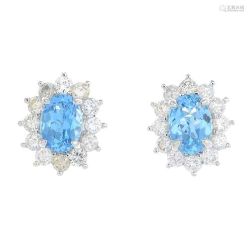 A pair of topaz and diamond cluster earrings. Each