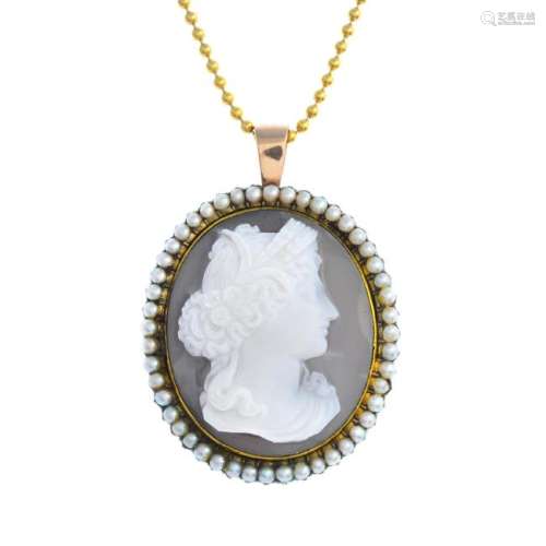 A mid Victorian gold onyx cameo pendant. The oval