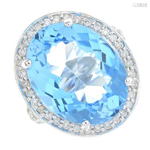 A topaz and diamond cluster ring. The oval-shape blue