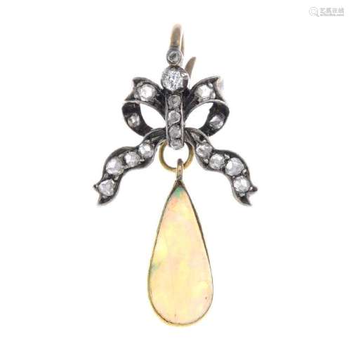 An opal and diamond pendant. The pear opal cabochon