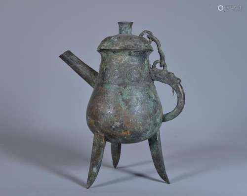 A BRONZE THREE-LEGGED RITUAL EWER, HE .( WESTERN ZHOU)