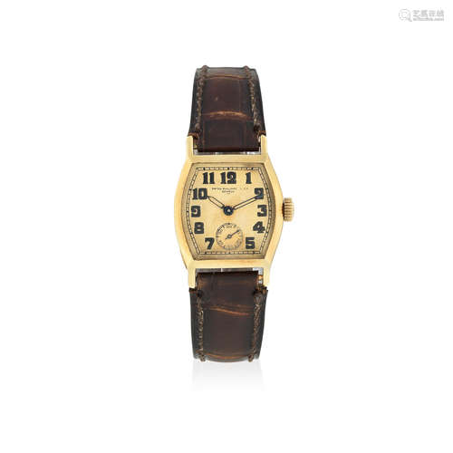 Manufactured in 1926, Sold 14th October 1927  Patek Philippe & Co, Geneve. An early 18K gold manual wind tonneau form wristwatch