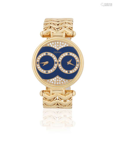 Circa 1980  DeLaneau for Kutchinsky. An 18K gold quartz bracelet watch with lapis lazuli and diamond set dual dial