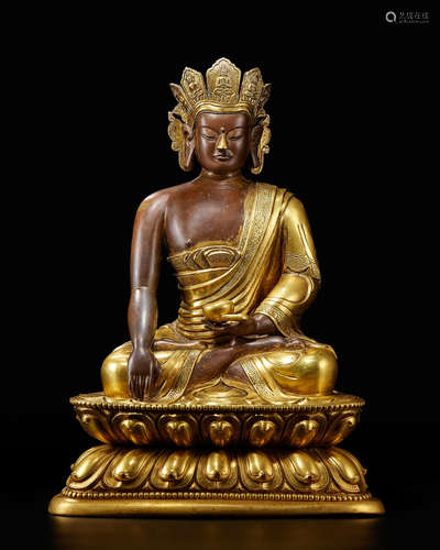 Qianlong A parcel-gilt bronze seated figure of Crowned Buddha