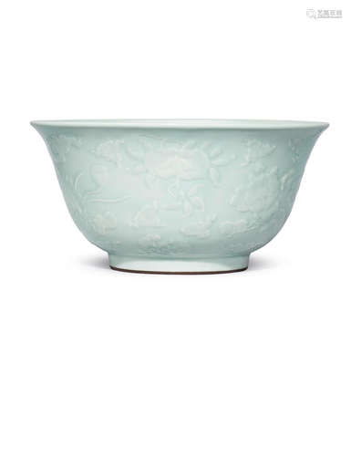 Yongzheng seal mark and of the period A very rare large celadon-glazed carved and moulded 'flowers and fruit' bowl