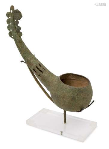 A Vietnamese bronze ladle, Dong Son culture, 1000-800 BCE, the curved handle modelled as an