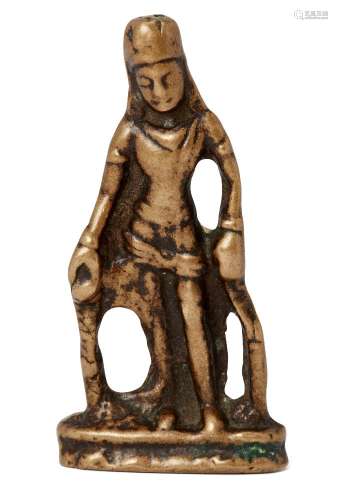 A Nepalese copper alloy votive figure, 12th century, standing with arms by his side, 6.5cm