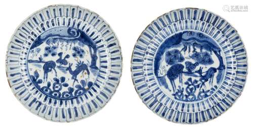 A pair of Chinese porcelain moulded saucer dishes, 17th century, painted in underglaze blue to the