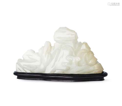 A Chinese white jade scholar's brush rest, 18th century, finely carved as a mountain, with a lingzhi